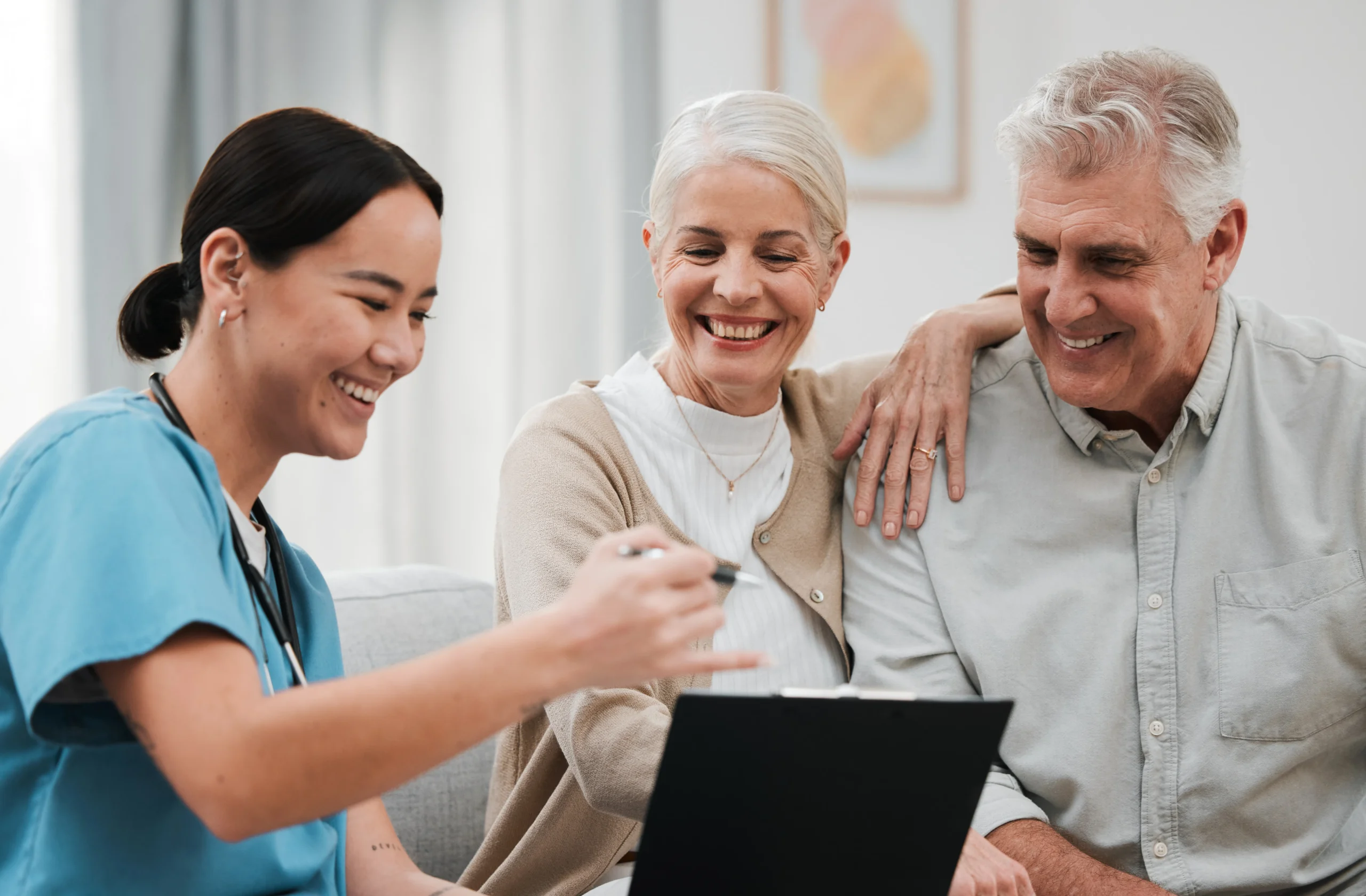 Nurse, healthcare and support with a senior couple in their home Nurse, healthcare and support with a senior couple in their home